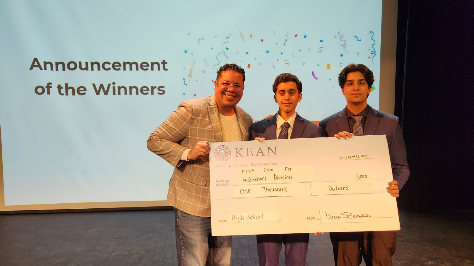 Karan Verma and Aditya Herekar holding the first-place check at the 2024 Kean Business Plan Competition